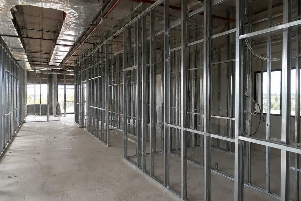 Commercial fit-out framed in steel stud by ReachOut, with partition walls, a suspended ceiling grid and services roughed in